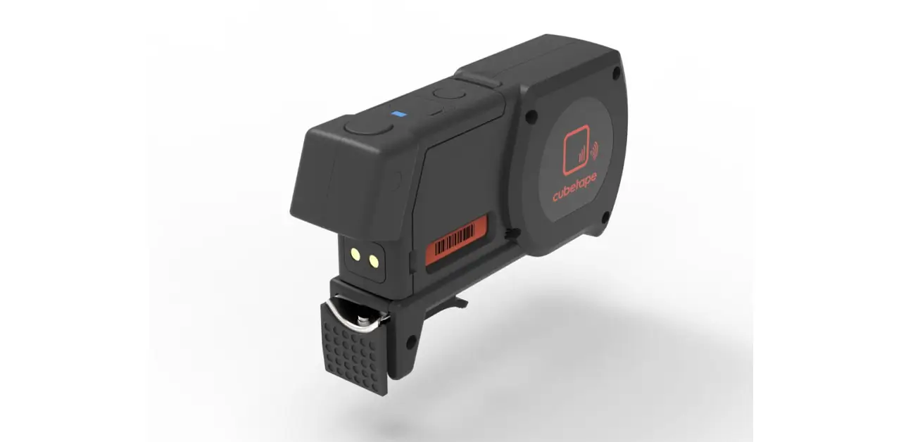 A Small Black Gadget With A Bright Red Button Prominently Displayed