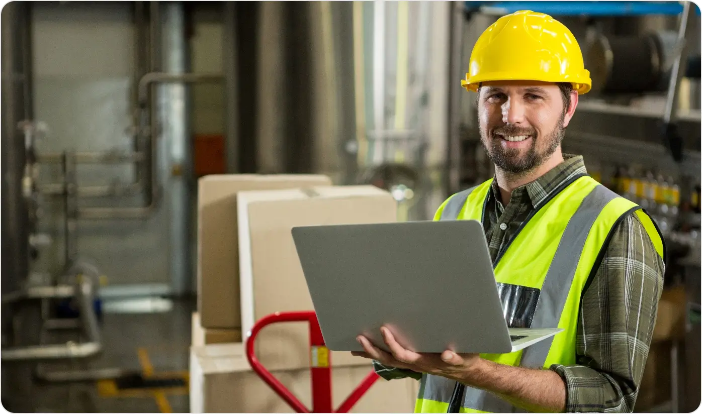 Smiling Male Worker Using Laptop Distribution Warehouse